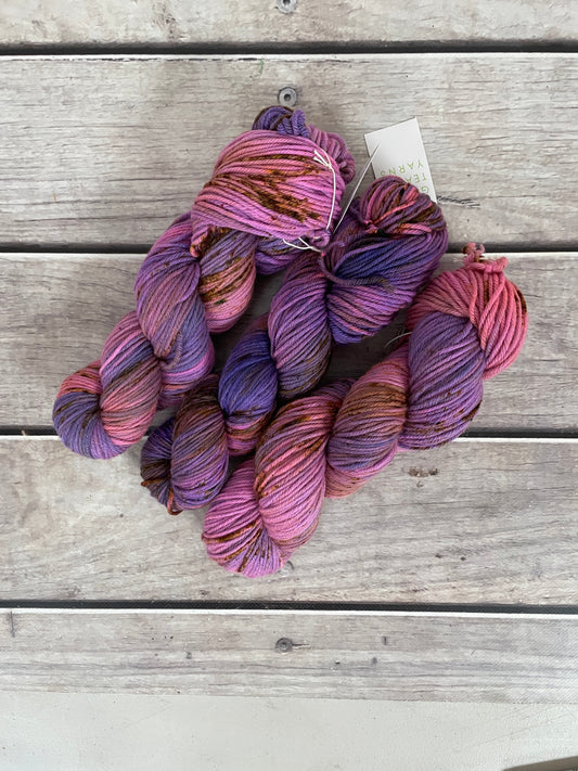 Bundle of multicolored yarn on a wooden surface